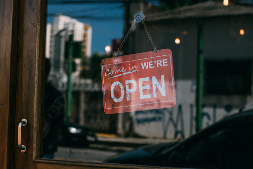 Business window with an "open" sign.