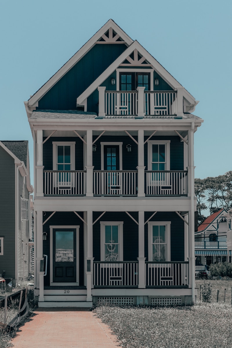 white and black wooden house with homeowners insurance during daytime